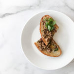 toasted bread on marble counter with olive tapenade