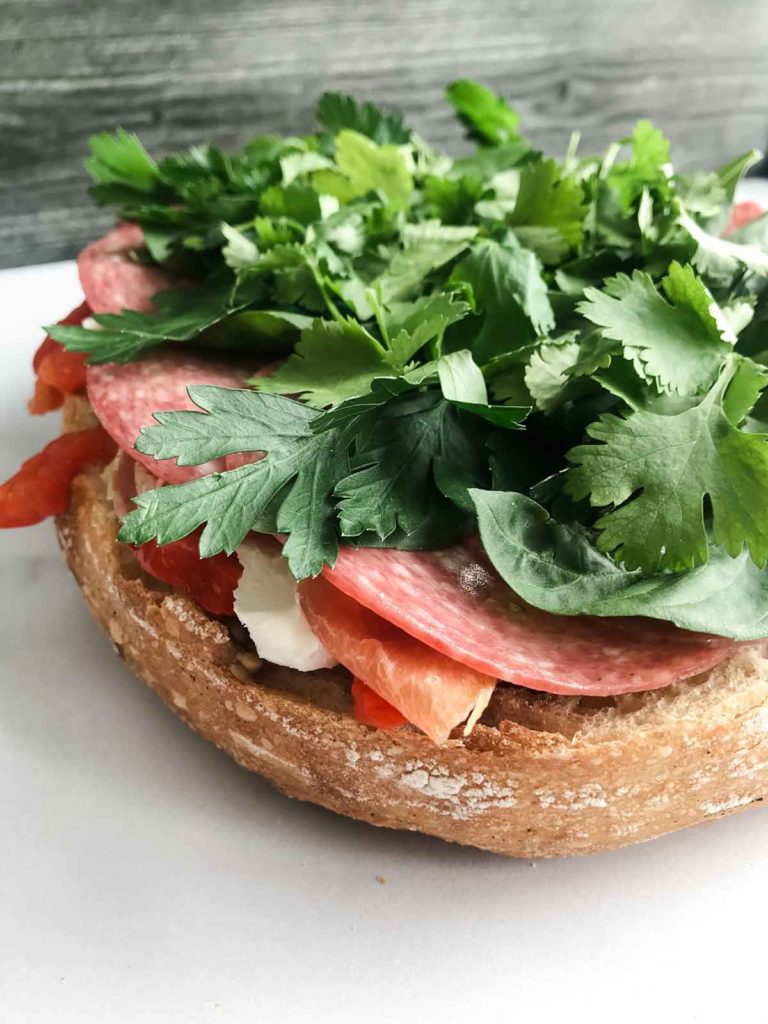 sandwich open faced with fresh herbs
